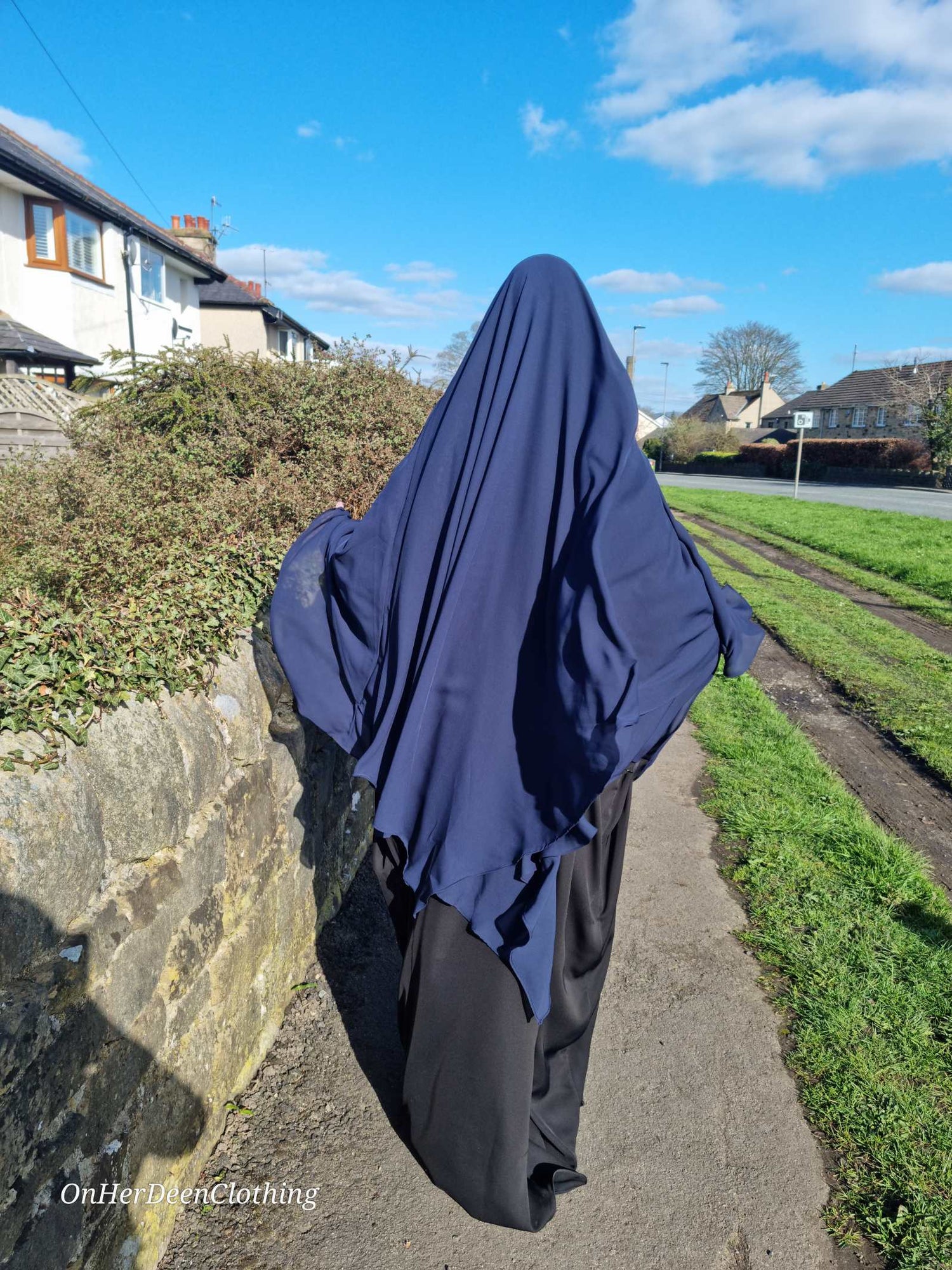 Woman wearing a chiffon 2 layer khimar in a navy colour from on her deen clothing