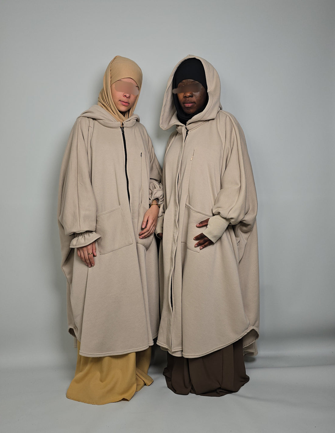 Two women in oversized poncho Abaya fleece musk white modest clothing