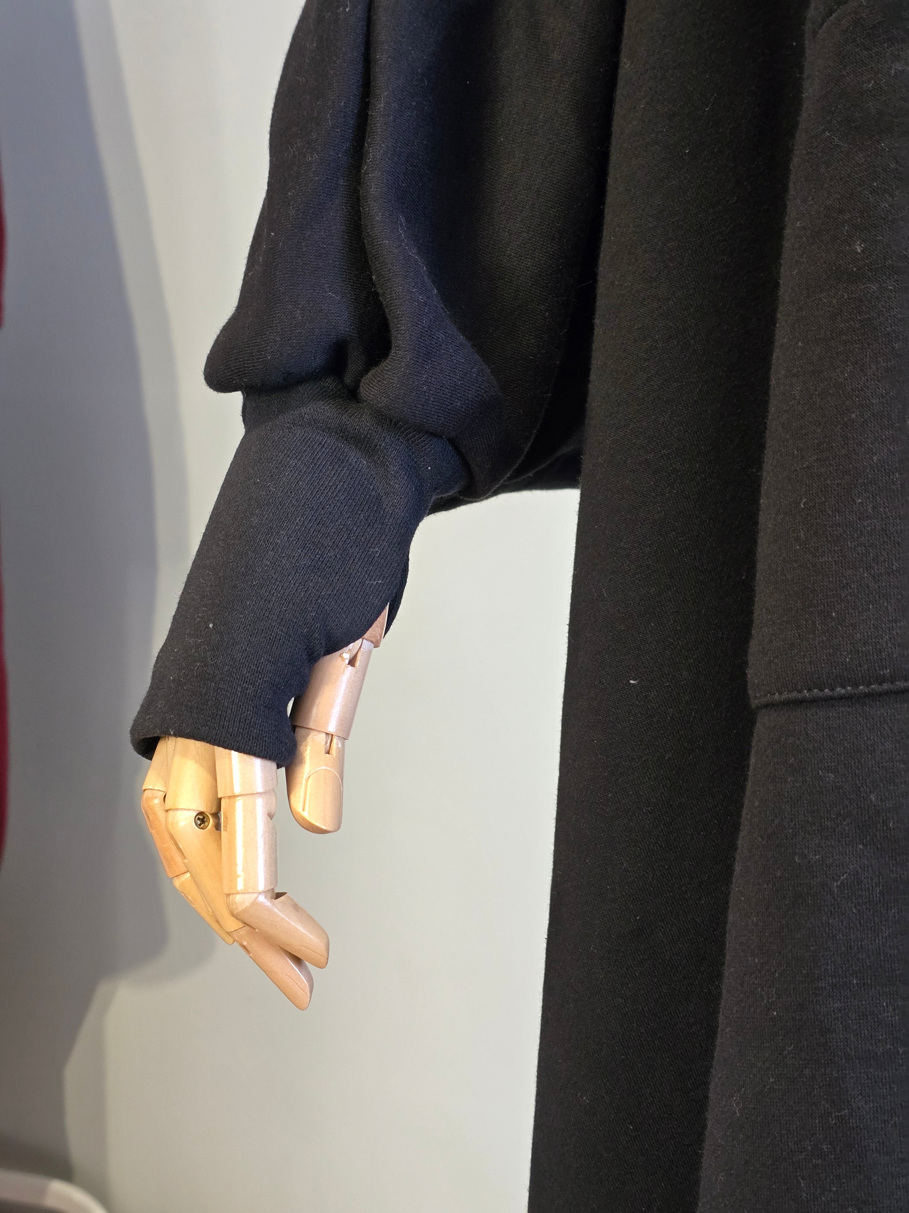 Gold mechanical hand wearing a thumbhole sleeve