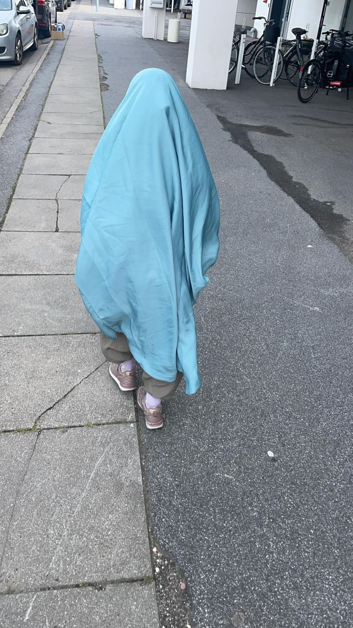 Girl in jilbab walking down the street