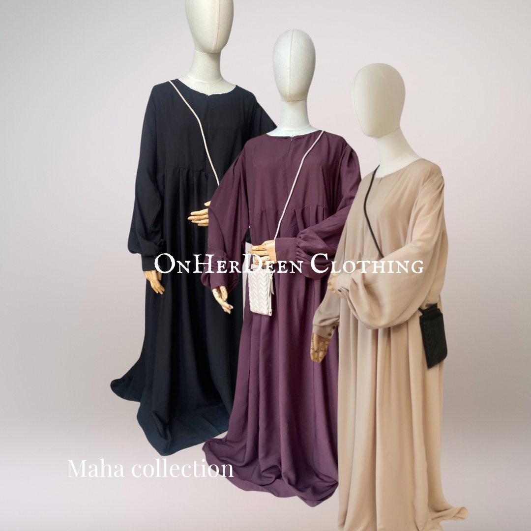 A mannequin displaying a black dusky rose and cream Russian abaya with long puffed sleeves, a high neckline, and a side pocket.