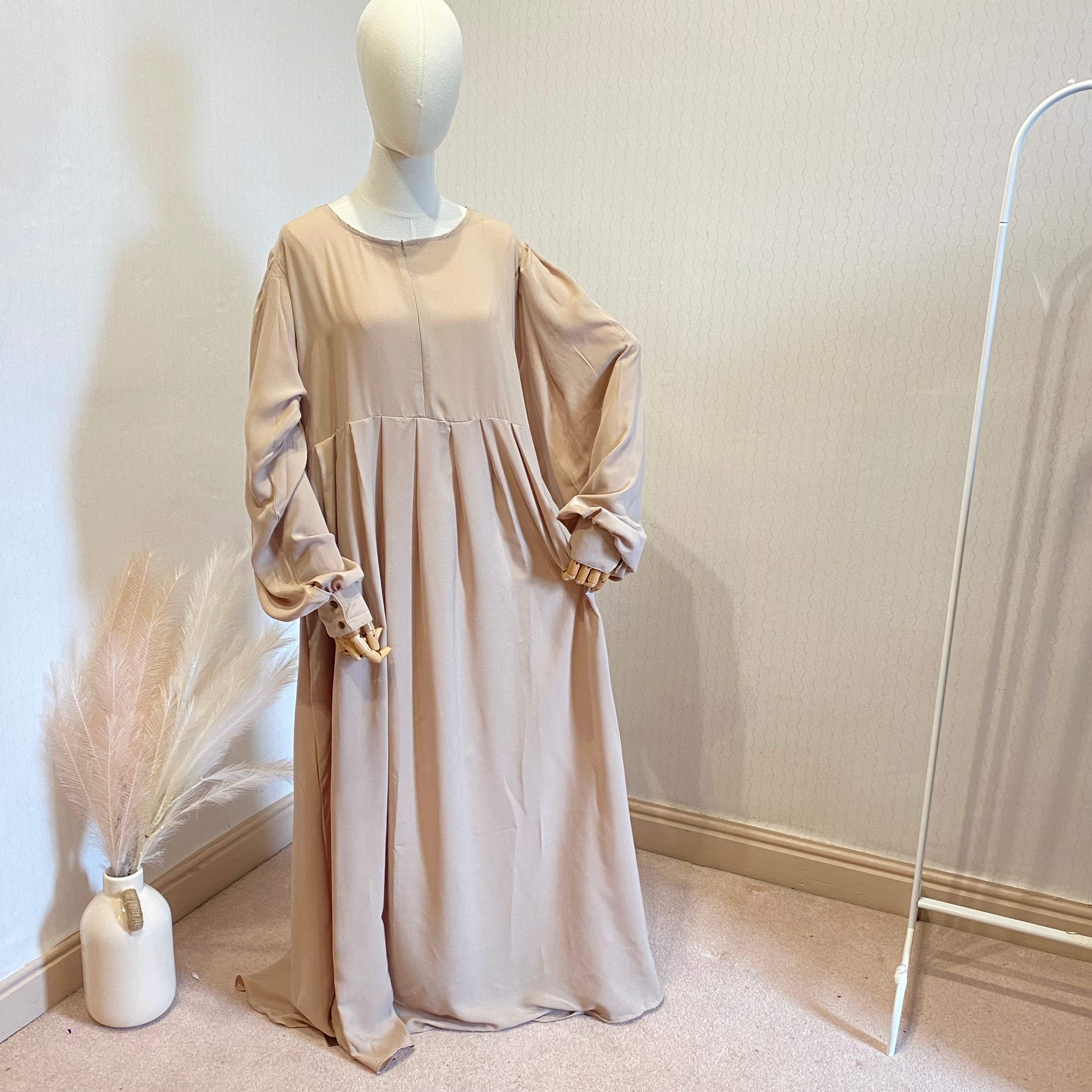 mannequin in a cream abaya dress with pockets