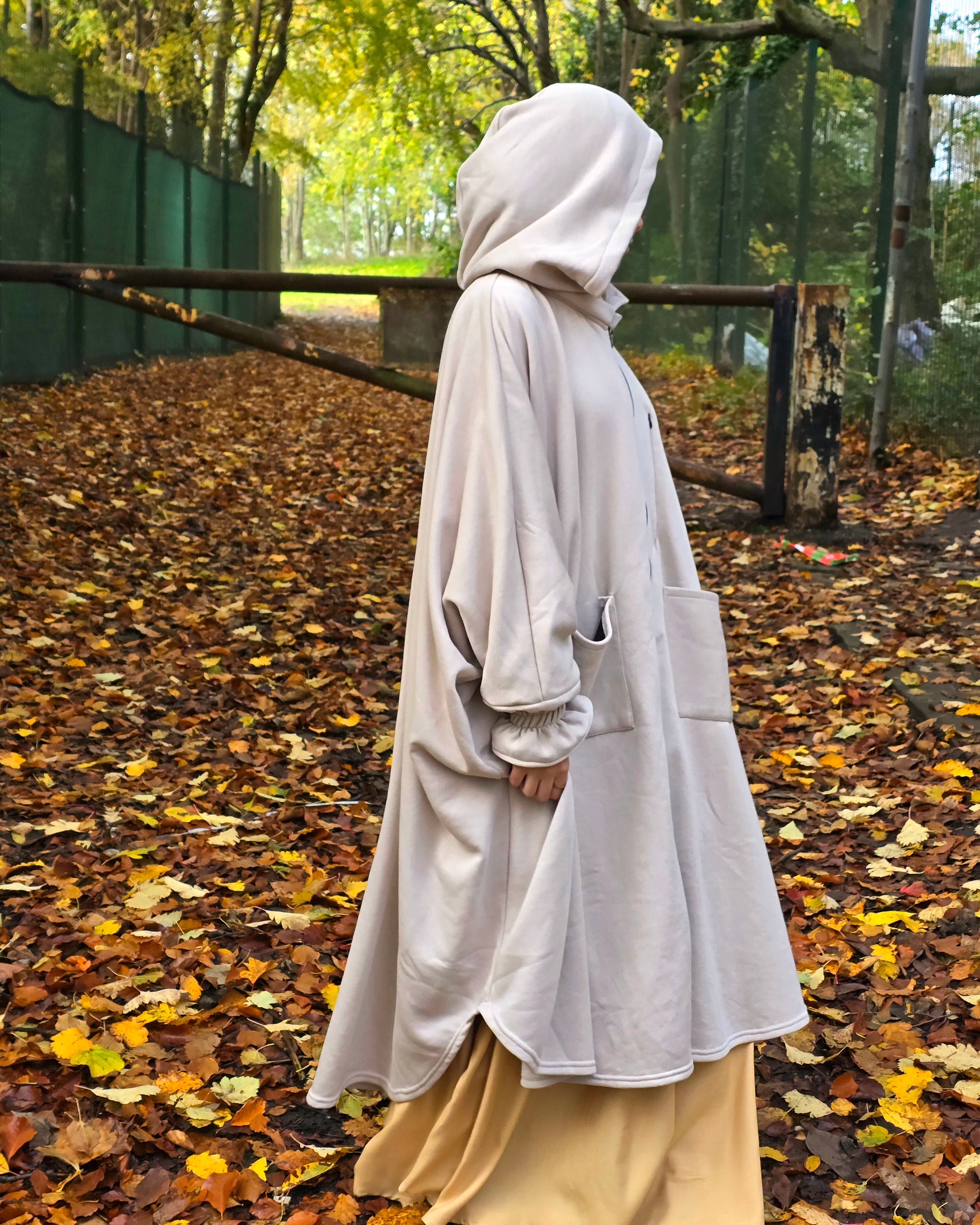 Women wear a oversized poncho Abaya fleece in autumn outdoors