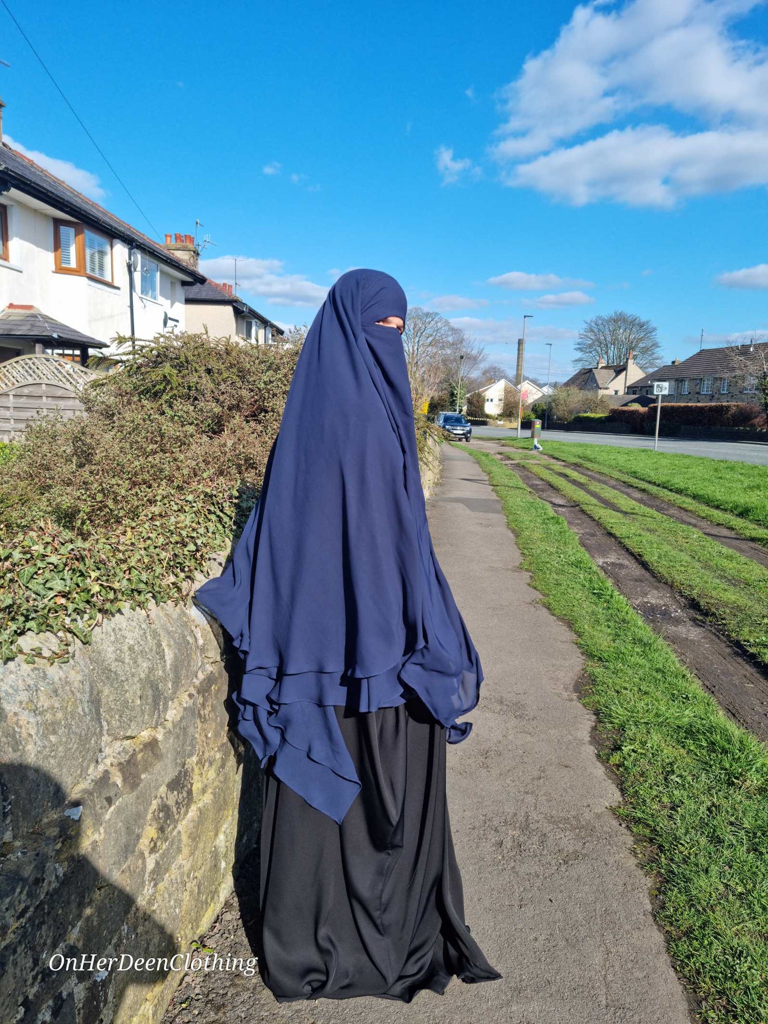 Woman wearing a Maxi 2 layer khimar in navy blue from on her deen clothing 