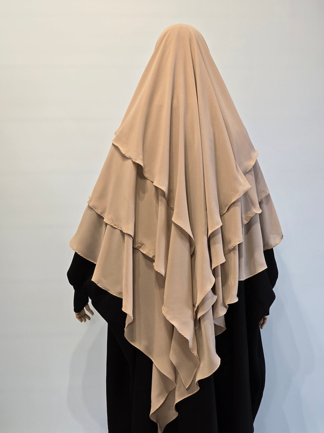 Beige  3 layer khimar on a person from the back on a white background