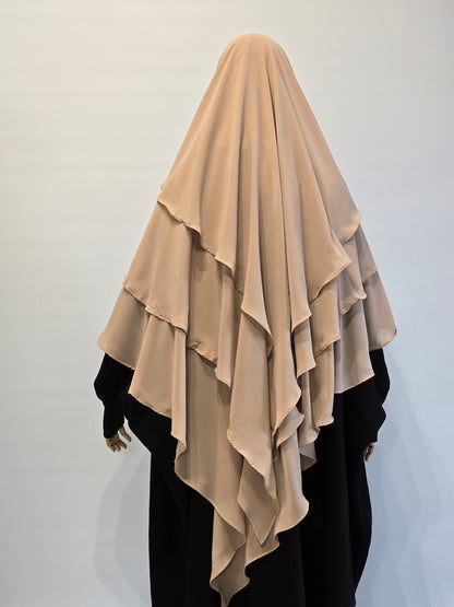 Beige  3 layer khimar on a person from the back on a white background