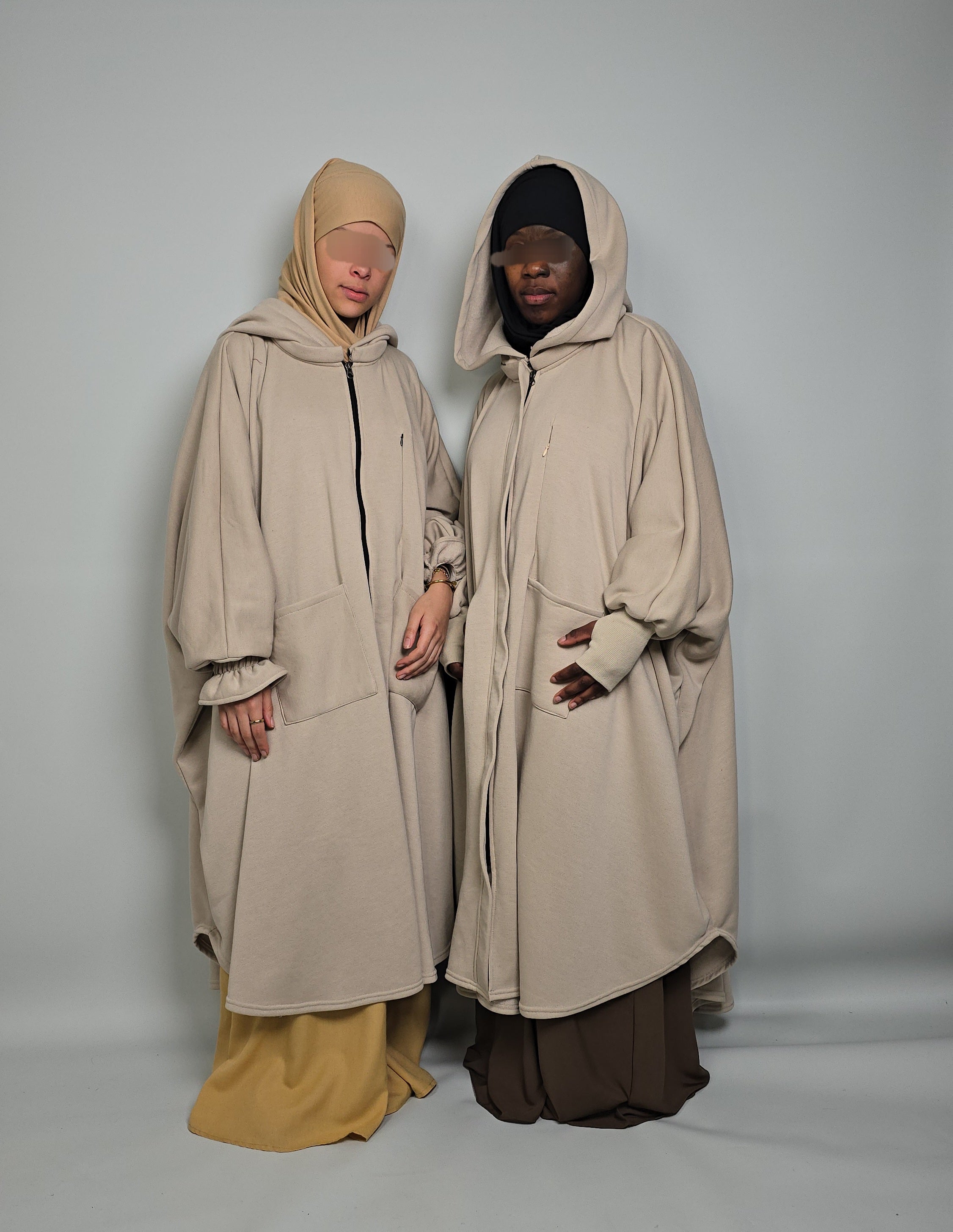 Two women in oversized poncho Abaya fleece musk white modest clothing 