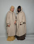 Two women in oversized poncho Abaya fleece musk white modest clothing 