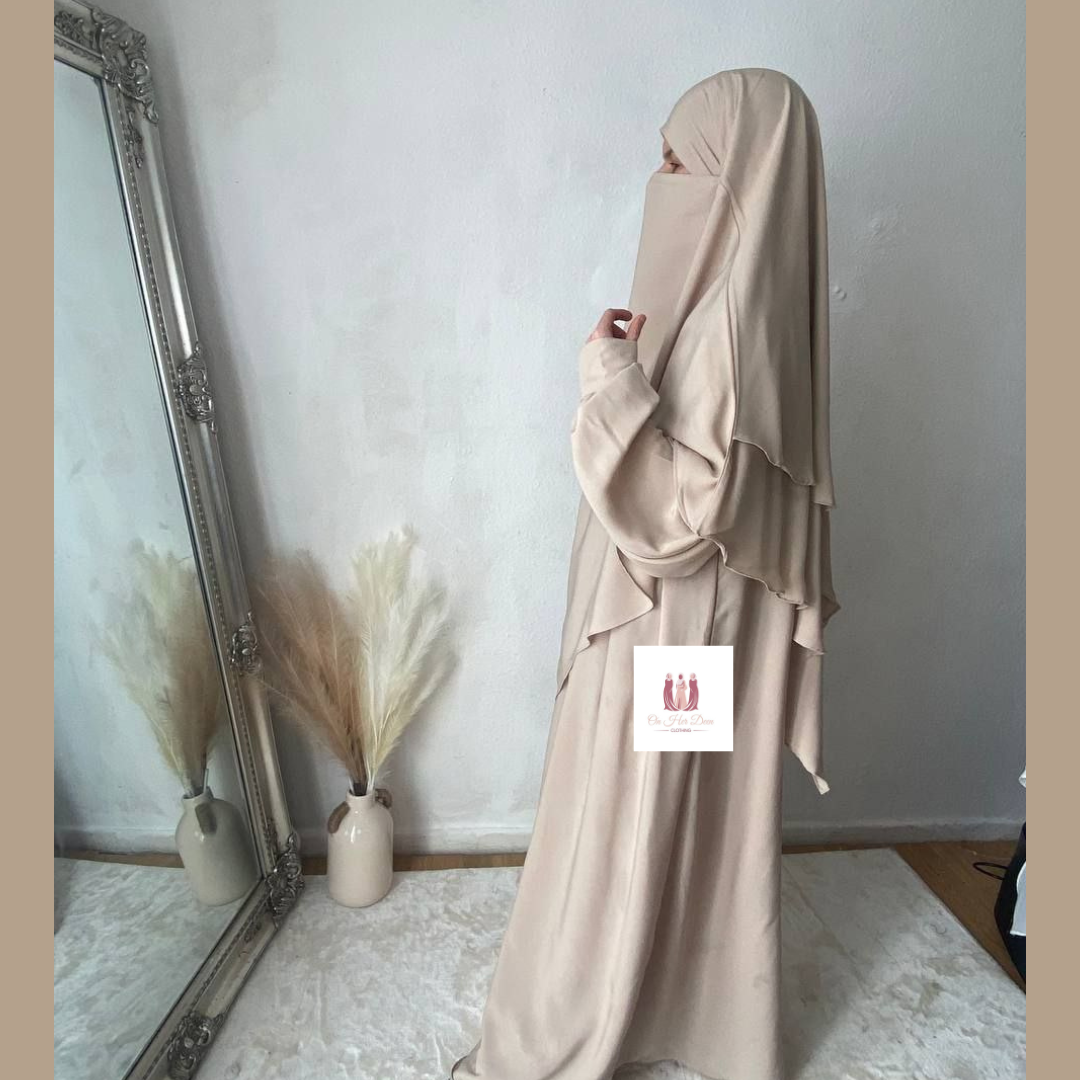 Women stood facing mirror in a abaya khimar set in the UK