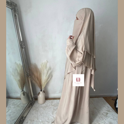 Women stood facing mirror in a abaya khimar set in the UK