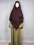 mannequin wearing a dark brown layered chiffon hijab khimar with a green dress on a white background 