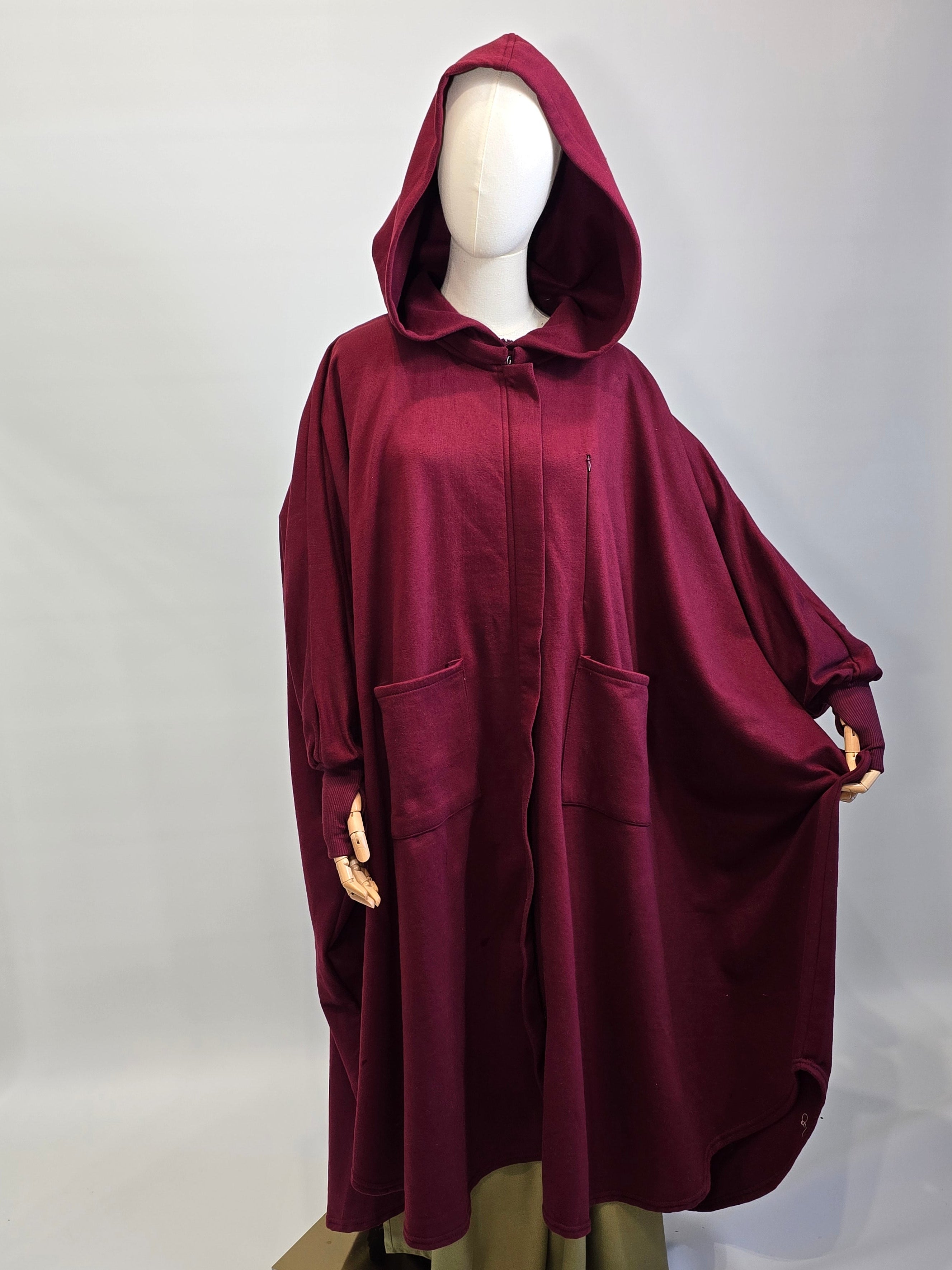 Maroon thumbhole sleeves poncho abaya on a mannequin stood on a white background 