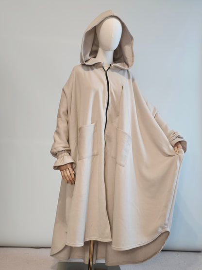 Oversized abaya hoodie musk white  on a mannequin against a light gray background
