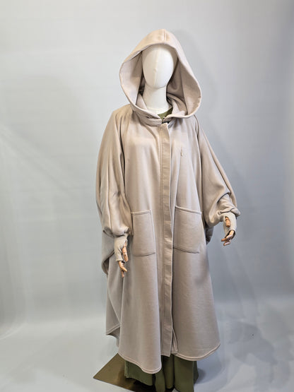 Mannequin wearing a beige trench coat on a light gray background