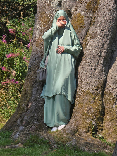 Women stood in woodland wear a pastel wide to piece jilbab 