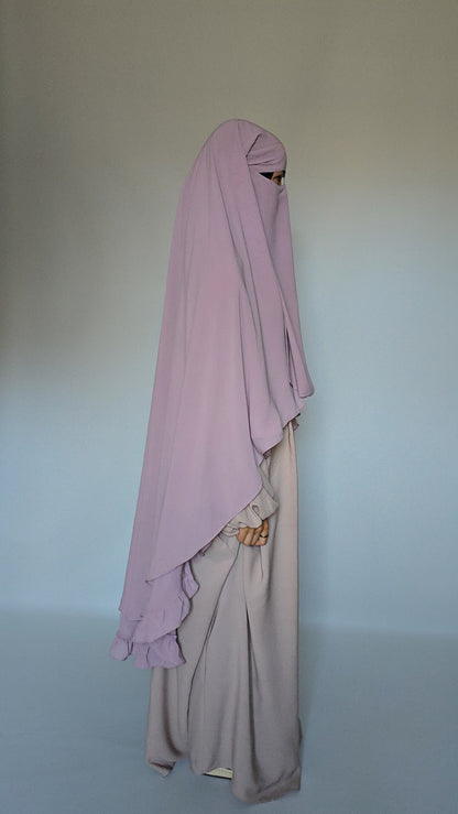 Wmen wear modest niqab garment with a cream abaya on a white studio background 