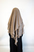 girl wearing a taupe girl hijab and black abaya  on a white background
