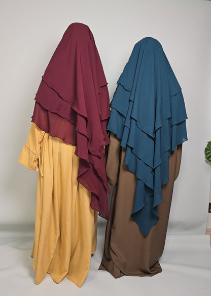 two women wearing chiffon khimars and colourful abaya 