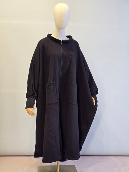 Black jacket on a mannequin against a plain background