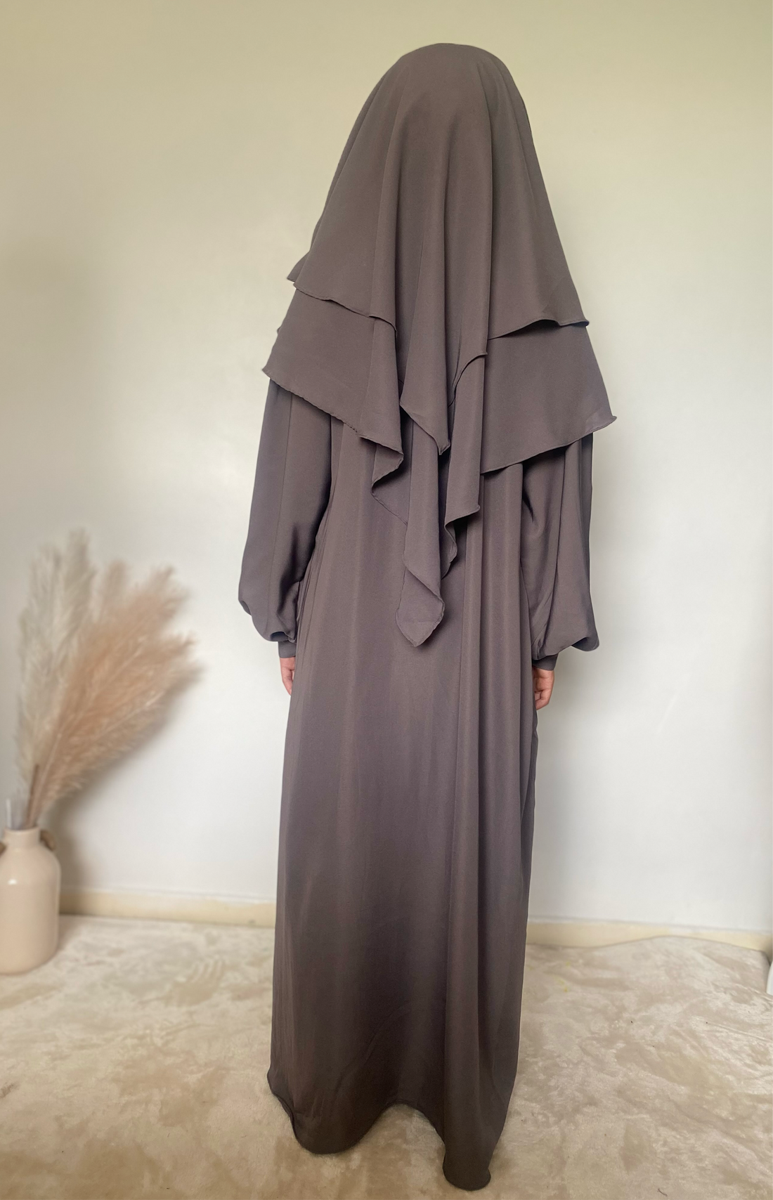 a girl in a 2 piece khimar and abaya set in grey color indoors