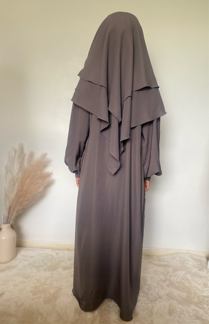 a girl in a 2 piece khimar and abaya set in grey color indoors