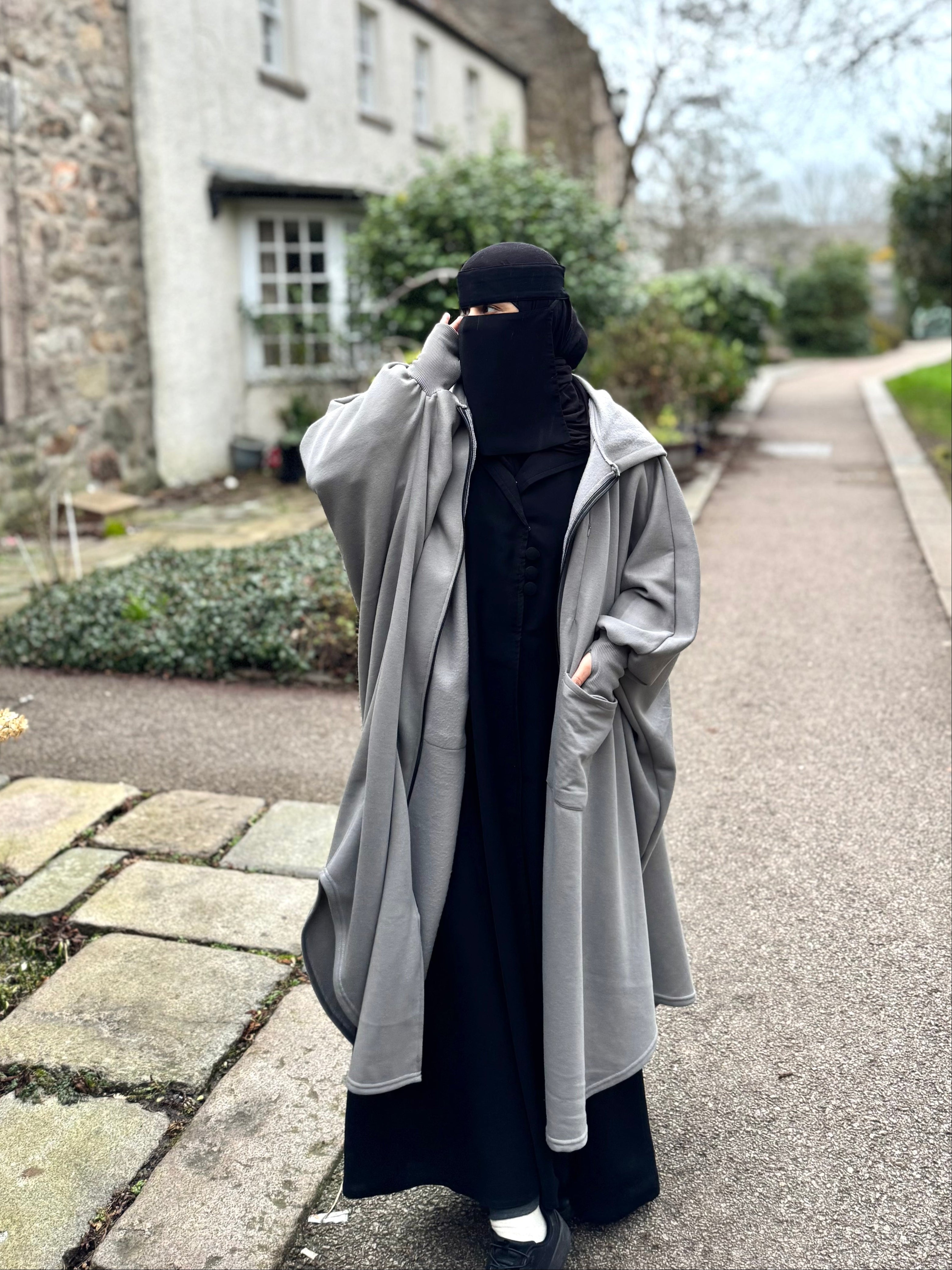 women in modest grey oversized poncho abaya fleece jacket