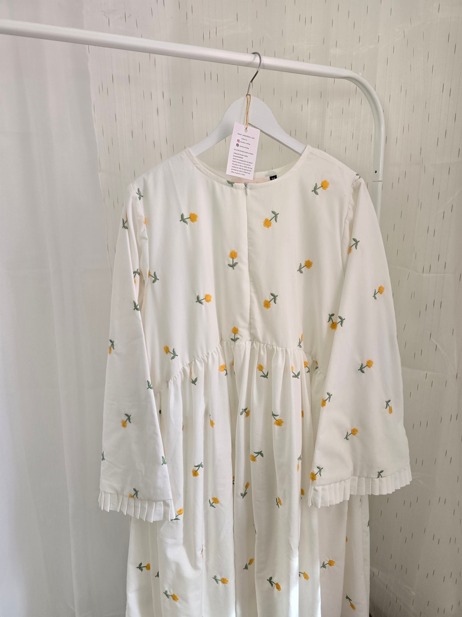 White dress with floral pattern on a white background