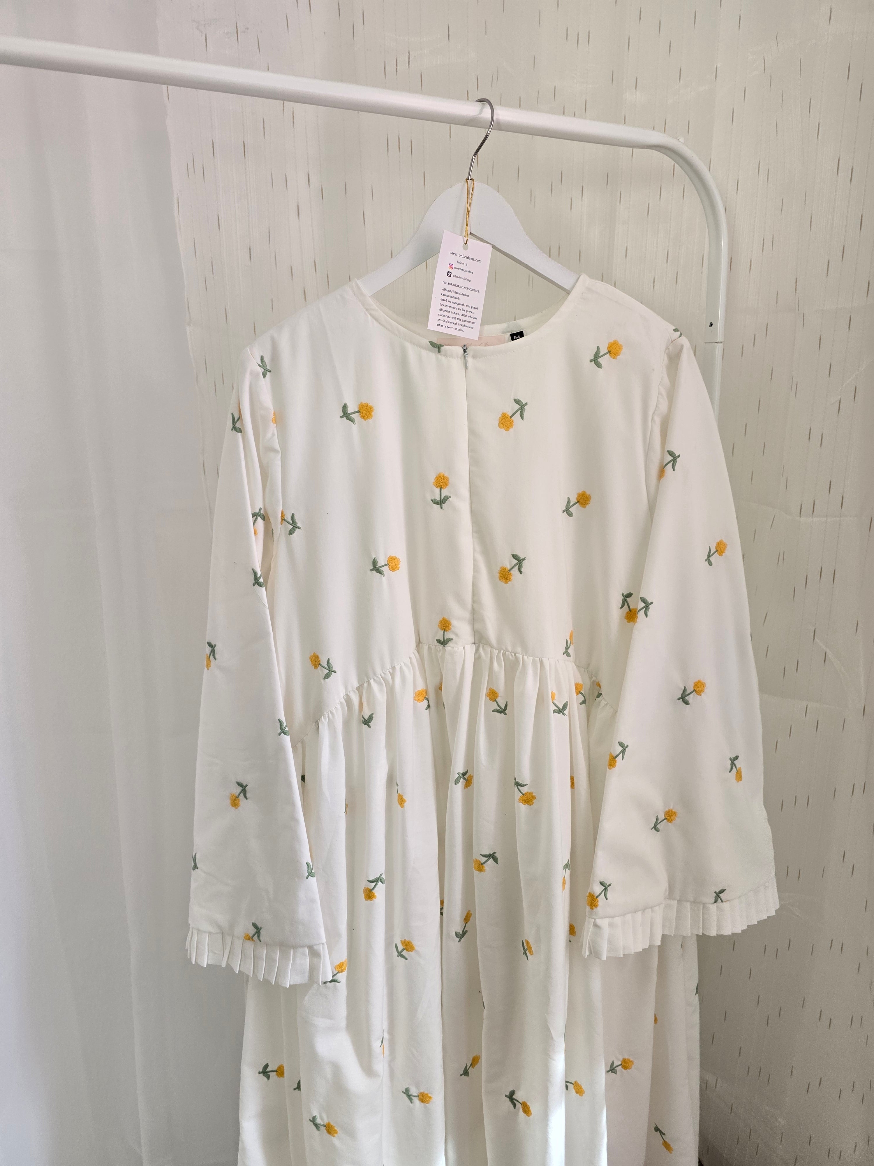 White dress with floral pattern on a white background